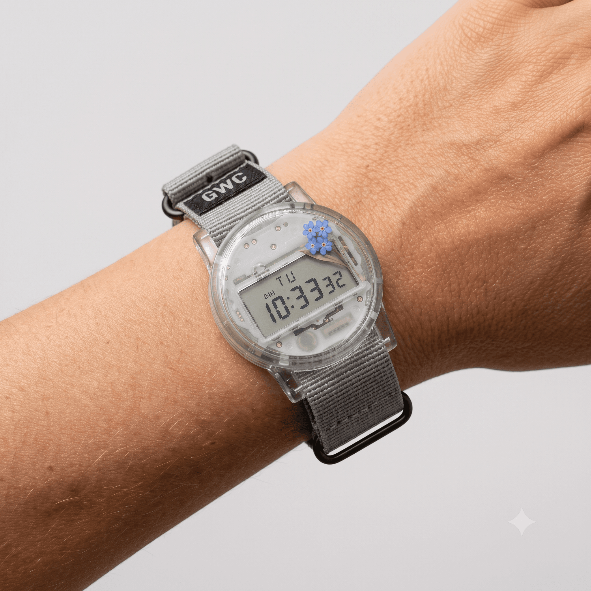 The Homoyo Watch, a clear resin case sealing a real quartz movement above a woven strap